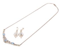 A modern Italian 9ct gold, treated blue topaz and diamond necklace and earning set.