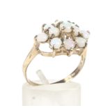 A 9ct gold hallmarked opal cluster ring. Set with eleven opals in three rows, Weight 2.