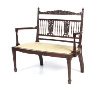 An Edwardian mahogany parlour two seater chair.