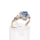 A 9ct gold, treated blue topaz and diamond heart-shaped cluster ring.