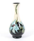 A Moorcroft Pottery Sea Holly pattern bottle-shaped vase. Printed and impressed marks, c.
