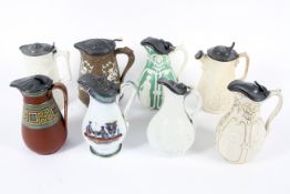 A group of 19th century Staffordshire pottery and stoneware relief-moulded pewter-mounted jugs.