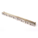 A mid 20th century gold and diamond bar brooch in Art Deco style.