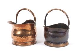 Two 19th century copper helmet shaped coal buckets, one with rear handle. H23.5cm & H19.5cm.
