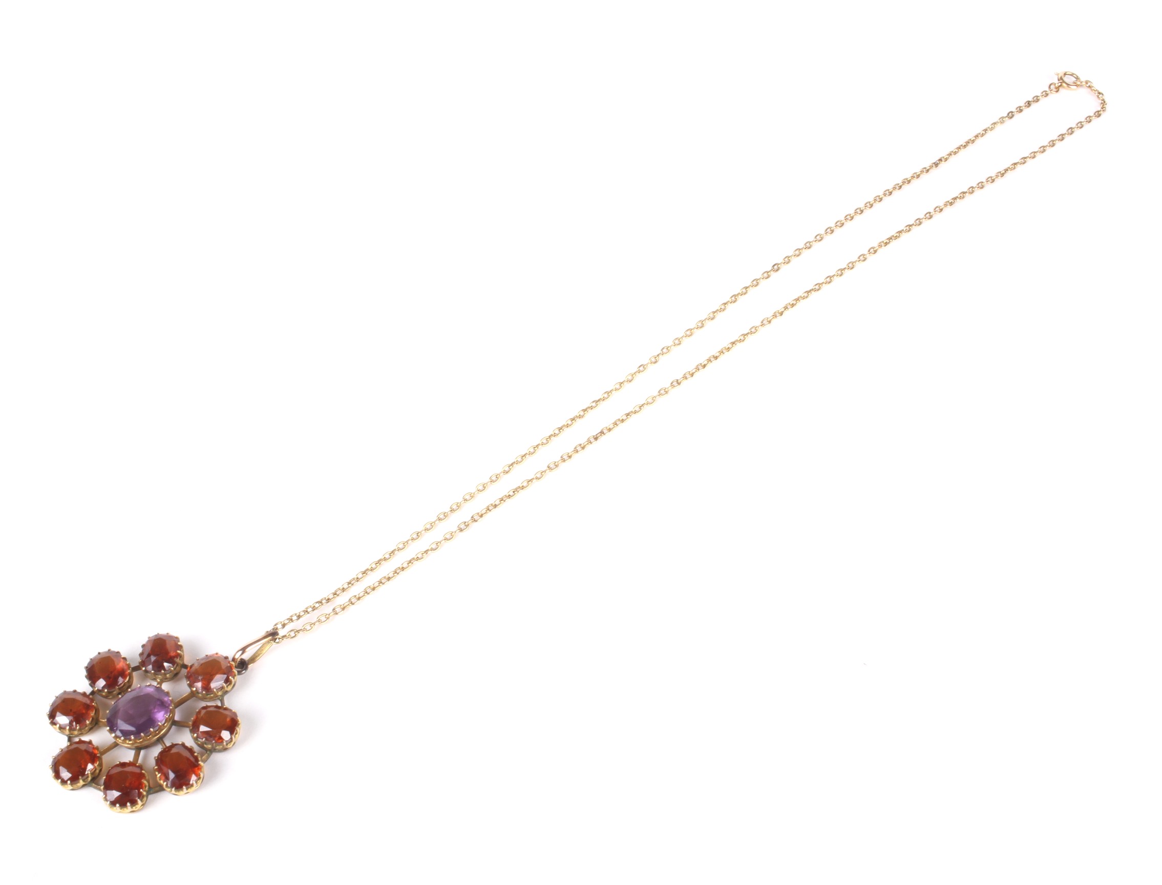 An early 20th century hessonite garnet and violet paste star-shaped cluster pendant and a chain. - Image 2 of 2