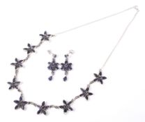A foreign white metal and iolite flower-head cluster necklace and a pair of earrings.