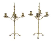 A pair of late 19th century adjustable brass four light candlesticks. In the style of WAS Benson.