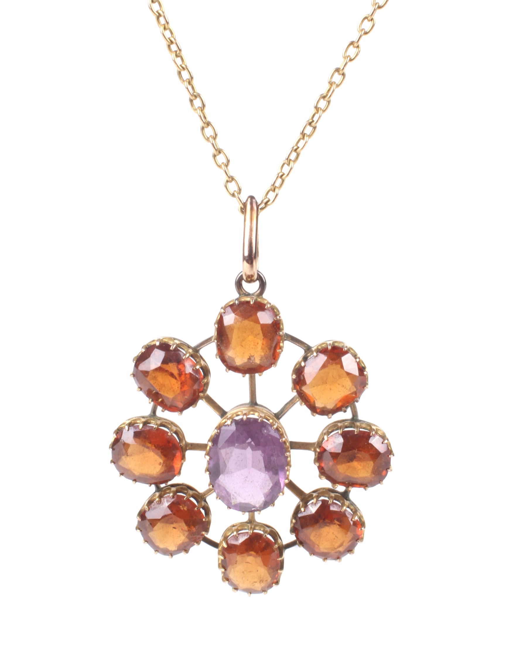 An early 20th century hessonite garnet and violet paste star-shaped cluster pendant and a chain.