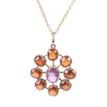 An early 20th century hessonite garnet and violet paste star-shaped cluster pendant and a chain.