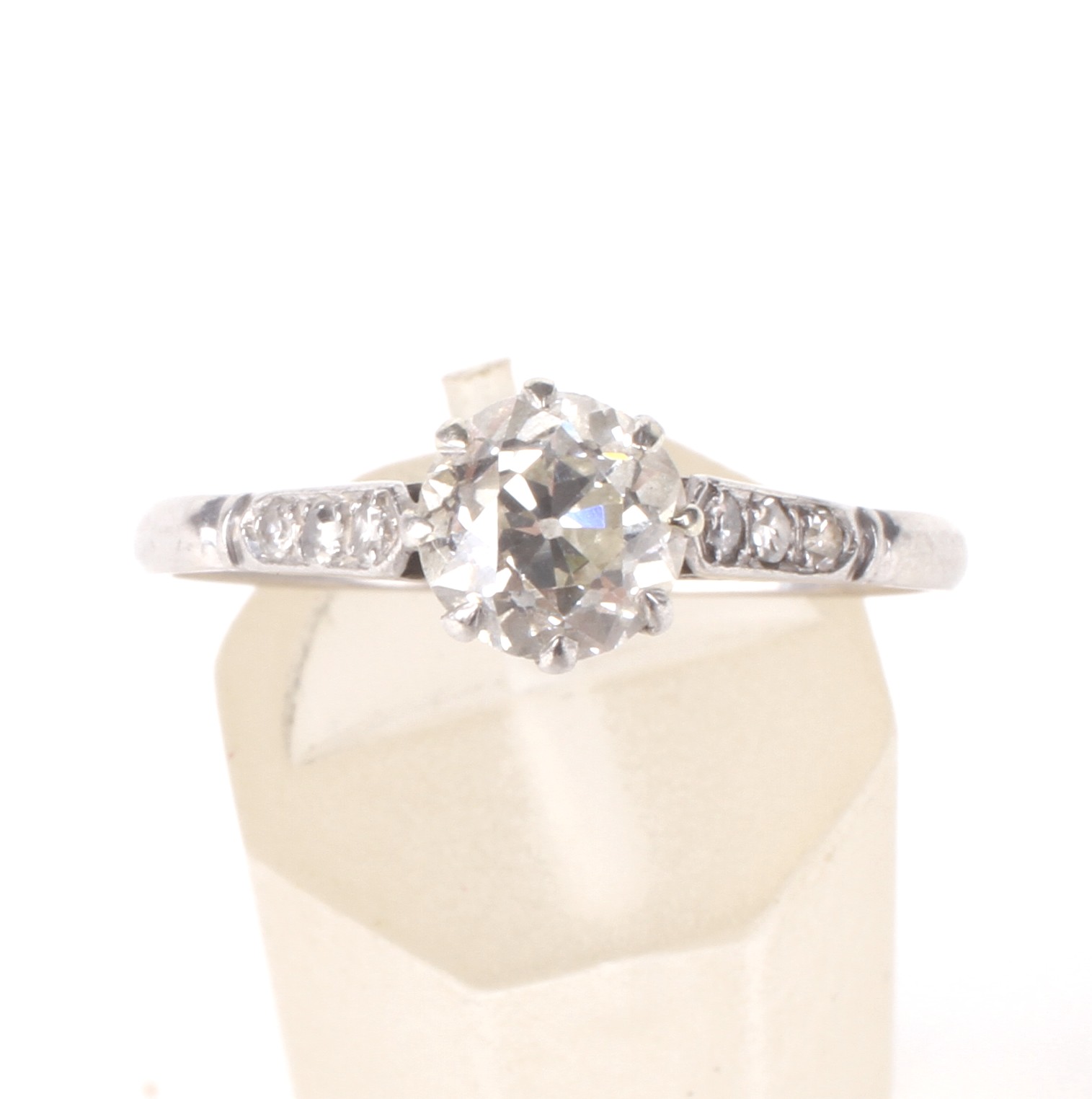 An early-mid 20th century platinum and diamond solitaire ring with small diamond shoulders. - Image 2 of 3