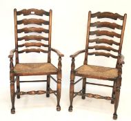 A pair of provincial rush seated ladder back armchairs.