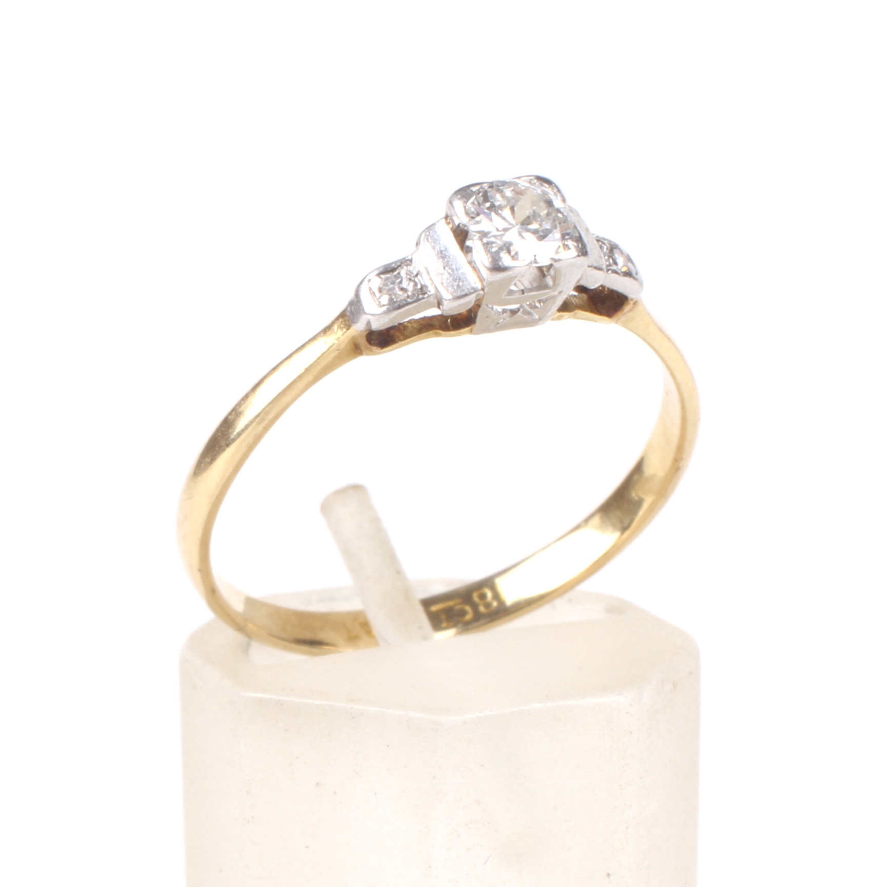 An Art Deco gold and diamond ring. The central early modern round brilliant approx. 0.