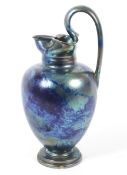 Art Nouveau pottery iridescent blue glazed ewer.