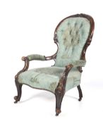 A Victorian mahogany framed spoon button back arm chair.