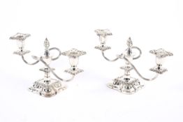 A pair of decorative silver plated two branch candleabra.