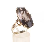 A vintage oval smoky quartz single stone ring.