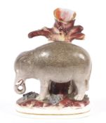 A 19th century Staffordshire pottery elephant spill vase.