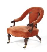 A Victorian mahogany framed upholstered elbow chair.