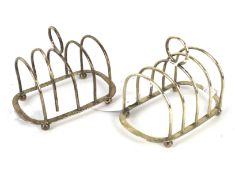 A pair of four branch silver toast racks.