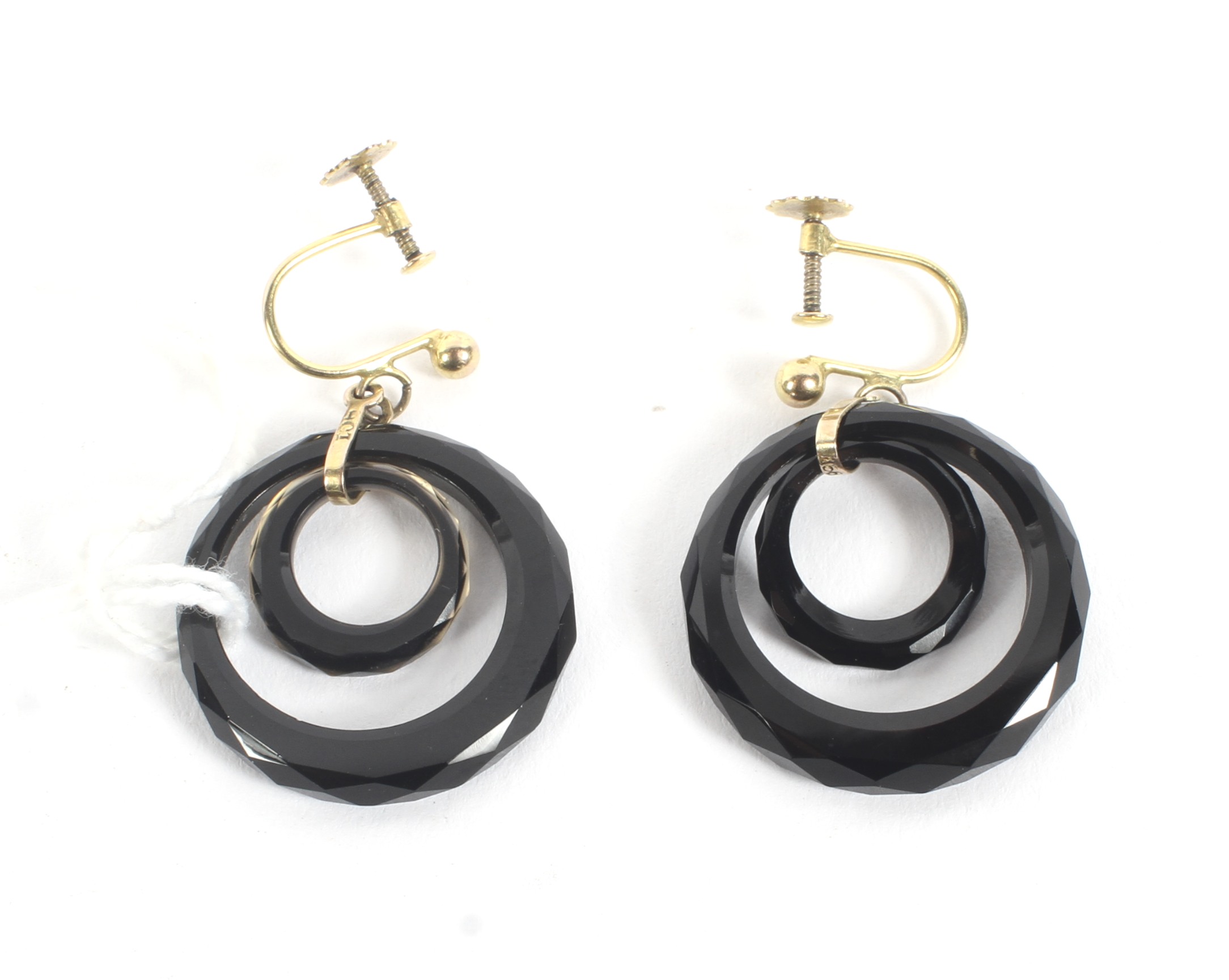 A pair of 9ct gold and onyx earrings. The gold structure supporting two rings of black onyx, L3.