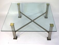 A square, glass topped coffee table.