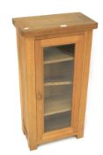 A contemporary oak display cabinet.