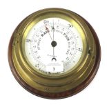 A 20th century brass wall mounting ships aneroid barometer by Cooke of Hull.