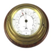 A 20th century brass wall mounting ships aneroid barometer by Cooke of Hull.