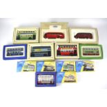 A collection of thirteen boxed Corgi diecast model buses and trains.