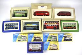 A collection of thirteen boxed Corgi diecast model buses and trains.