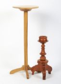 An oak ecclesiastical candle stand and a stained candle holder.