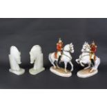 A pair of carved stone bookends in the form of horses and pair of Austrian ceramic figures of