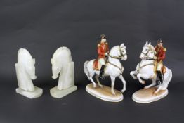 A pair of carved stone bookends in the form of horses and pair of Austrian ceramic figures of