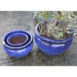 Three contemporary blue glazed garden pots.