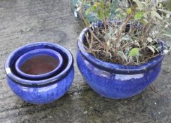 Three contemporary blue glazed garden pots.