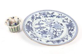 A 19th century Chinese blue and white plate and a cup. The first decorated with blossom, diam 27.