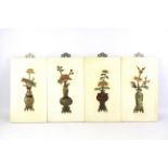 A set of four Chinese plaques depicting the four seasons in stone and resin.