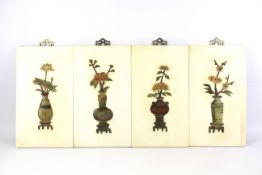 A set of four Chinese plaques depicting the four seasons in stone and resin.