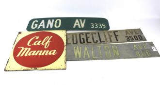 A painted 'Calf Manna' metal sign and three contemporary road style signs.