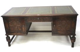 A 20th century reproduction oak desk in the 19th century style.