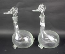 A pair of contemporary blown glass decanters in the forms of ducks.