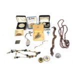 A assortment of costume jewellery and coins.