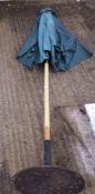 A garden umbrella on cast metal base.
