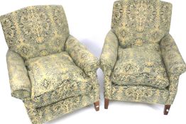 A pair of upholstered armchairs.