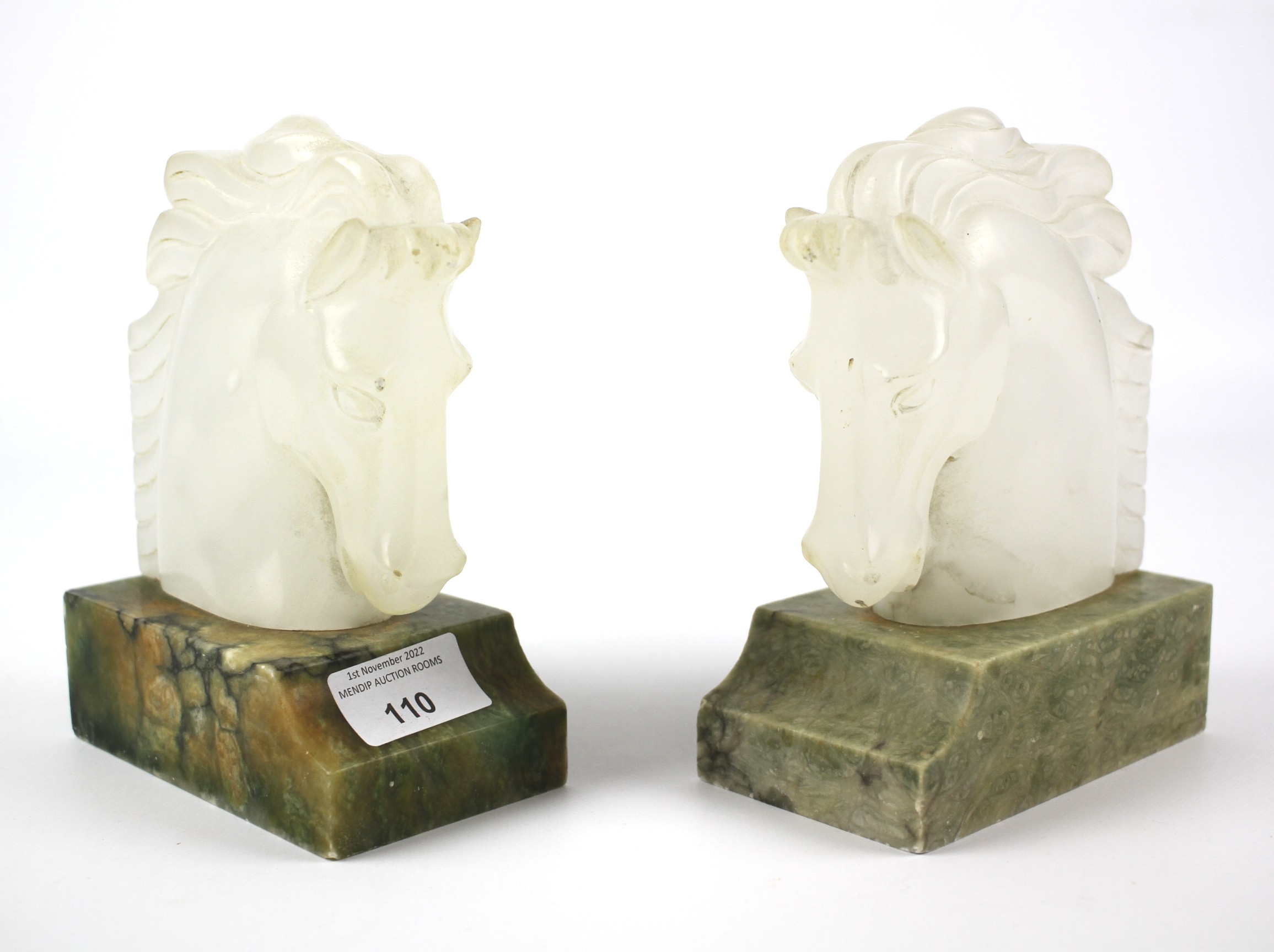 A pair of early 20th century carved onyx horse head book ends.