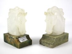 A pair of early 20th century carved onyx horse head book ends.