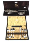 A Victorian boxed silver fish server and boxed set of silver plated teaspoons and sugar nips.