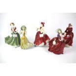 A collection of four Royal Doulton figures of ladies and another.