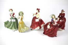 A collection of four Royal Doulton figures of ladies and another.