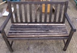 A stained wooden garden bench.